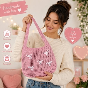 May include: A pink crochet shoulder bag featuring a single strap and five small white embroidered bow accents on the front. The bag has a textured, woven appearance and is held up to display the front panel clearly. The design is simple and functional.