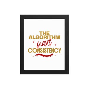 May include: A framed wall art piece featuring a white background with the gold text THE ALGORITHM and CONSISTENCY, separated by the red script word fears. Small red four-pointed stars and a red wavy line accent the text within a black frame.