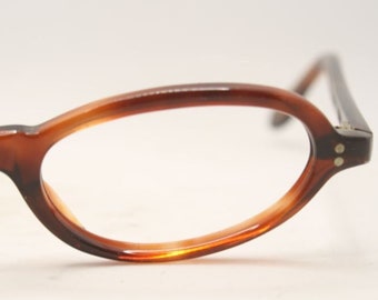 May include: Brown tortoise shell oval-shaped eyeglasses with clear lenses.