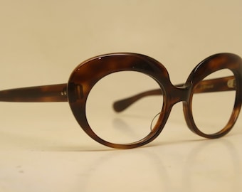 May include: A pair of tortoise shell oval-shaped eyeglasses with clear lenses.