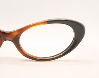 May include: A pair of brown and black cat-eye glasses with a tortoiseshell pattern on the frame.