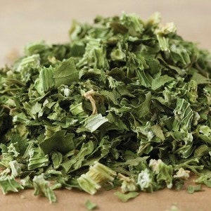 May include: A close-up of a pile of dried green herbs, likely parsley or cilantro, chopped into small pieces.