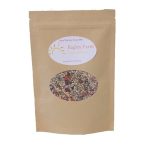 May include: A brown paper bag with a clear window showing a mix of dried ingredients. The bag has a white label with the text "Bagley Farm Taste and See" and "Beef Barley Soup Mix".