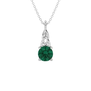 May include: A silver pendant necklace featuring a round, faceted dark green gemstone set in a four-prong mount. The pendant is suspended from a delicate silver chain and includes an intricate, interwoven silver knotwork design above the stone.
