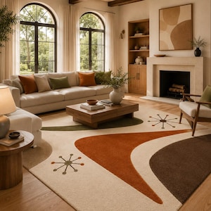 May include: A large area rug featuring a cream-coloured background with abstract shapes in burnt orange, dark brown, and olive green. The design includes stylised starburst motifs in dark brown and orange, creating a geometric pattern across the surface.