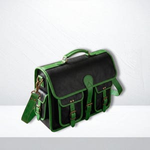 May include: A black satchel bag with vibrant green trim, featuring a top handle, a detachable shoulder strap, and two front pockets. The bag is secured with multiple buckle straps and metallic hardware, showcasing a structured design with visible stitching.