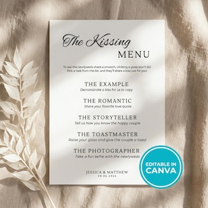 May include: A white rectangular wedding sign titled The Kissing Menu with black text listing tasks for guests to prompt a kiss from the couple. The sign includes the names Jessica & Matthew and the date 08.06.2026, with a blue circular badge stating Editable in Canva.