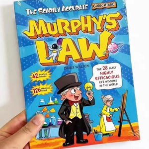May include: A book titled The Scarily Accurate Caricature Murphy's Law by Doris Walton. The blue cover features a cartoon man in a top hat holding a lightbulb, a woman painting at an easel, laboratory equipment, and the text 42 proctical mmirikl + 126 mavtous motob.