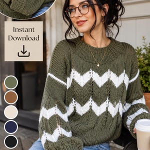 May include: A long-sleeved knit sweater featuring an olive green base with horizontal white chevron stripes and vertical eyelet detailing. The sweater has a ribbed crew neckline, ribbed cuffs, and a ribbed hem, showcasing a textured knit pattern.