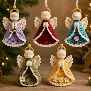 May include: Five handmade crochet angel ornaments in lavender, deep red, teal, olive green, and yellow. Each figure features a round head, white wings, a gold halo, and hands clasped in prayer. The dresses are decorated with small crocheted flowers.