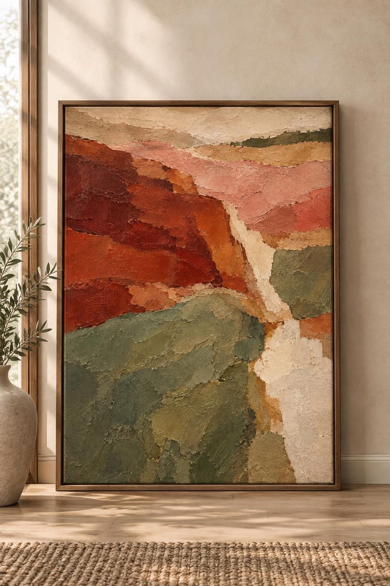 May include: A vertical rectangular framed painting featuring a textured landscape with thick impasto brushstrokes. The composition displays layered sections of deep red, burnt orange, muted sage green, soft pink, and cream tones in a canyon-like scene.
