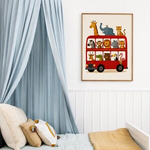 May include: A framed wall art print featuring a red double-decker bus filled with various illustrated animals, including a giraffe, elephant, zebra, monkey, lion, rhino, tiger, crocodile, bear, toucan, and flamingo, set against a cream background.