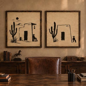 May include: Two square wall art pieces featuring black ink illustrations on a beige background. The left print shows a desert scene with a cactus, a building, and a figure. The right print depicts a similar desert scene with a cactus and a figure.