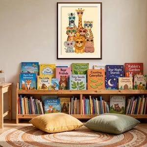 May include: A framed wall print featuring a colorful illustration of a zebra, giraffe, leopard, tiger, monkey, elephant, lion, and hippo wearing sunglasses. Below, a wooden bookshelf holds numerous children's books with various titles.