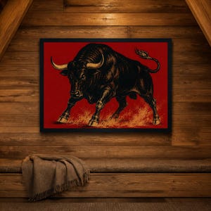 May include: A framed rectangular wall art piece featuring a detailed black bull illustration set against a solid red background. The bull is depicted in a charging stance with golden-toned horns and hooves, standing over a textured orange ground.