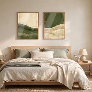 May include: Two rectangular wall art prints featuring abstract landscape designs with layered hills in shades of forest green, olive, and cream. Each print displays a minimalist sun icon and textured, earthy color blocks in a vertical orientation.