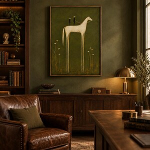 May include: A framed wall art print featuring a tall, slender white horse with elongated legs standing on a dark olive green background. Two small dark figures with star-shaped heads are positioned on the horse's back, surrounded by thin floral stems.