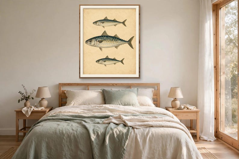 Vintage mackerel fish wall art in a wood frame above a bed with cream and sage linen bedding in a calm bedroom — antique nautical print, printable wall art