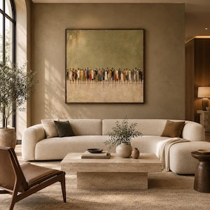 May include: A large square wall art piece featuring a crowd of small, abstract figures in muted tones of brown, orange, and blue against a textured olive green background, displayed in a thin dark frame above a cream-colored curved sofa.