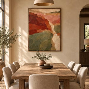 May include: A large rectangular framed wall art piece featuring an abstract landscape painting with thick, textured brushstrokes in shades of deep red, muted green, soft pink, and cream, displayed above a wooden dining table and chairs.