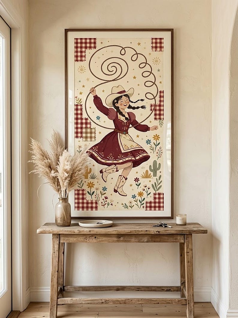 Framed cowgirl wall art in an entryway above a rustic wooden console table — western folk art print, tall printable decor