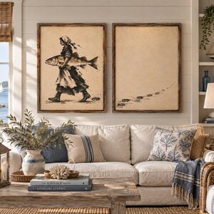 May include: Two rectangular wall art pieces in dark wood frames. The left print features a black ink illustration of a person in a headscarf carrying a large fish. The right print shows a trail of footprints leading across a beige background.