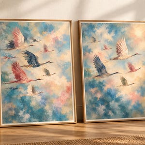 May include: Two framed wall art prints featuring a flock of birds in flight against a soft, painterly sky of blue, pink, and cream clouds. The birds are depicted in shades of white, grey, and pink, captured in various poses of movement.