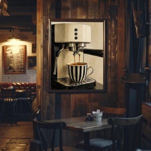 May include: A framed wall art print depicting a white espresso machine brewing coffee into a black and white striped ceramic mug. The machine features three circular buttons on the front and a metallic portafilter, with dark liquid flowing into the cup.
