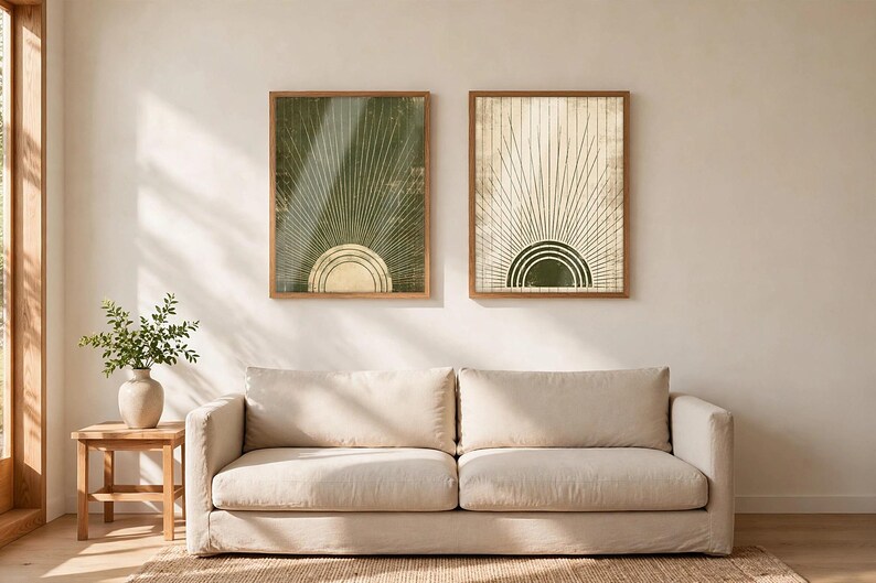 May include: Two rectangular framed wall art prints featuring a sunburst motif. The left print has a dark green background with a light-colored semi-circle, while the right print has a light background with a dark green semi-circle.