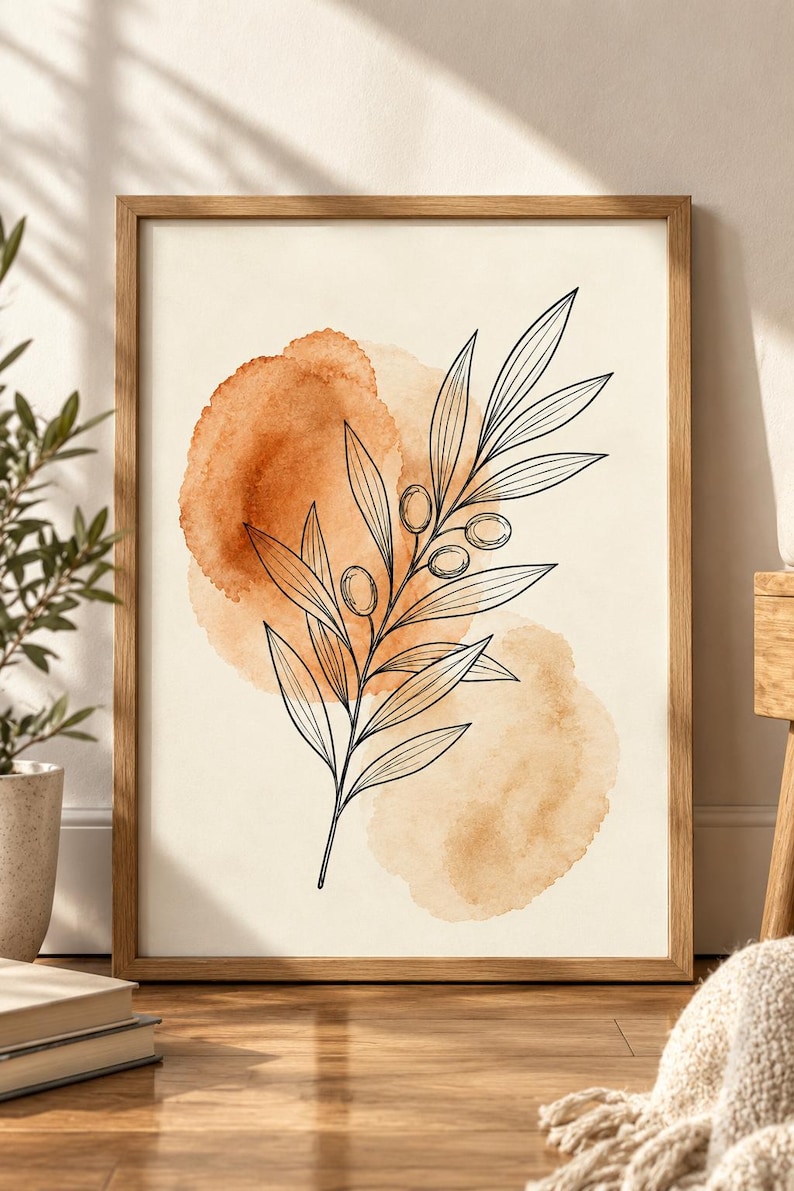 May include: A framed wall art print featuring a black line drawing of an olive branch with leaves and small fruits centered over two overlapping watercolor circles in shades of burnt orange and light tan on a cream-colored background.