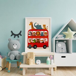 May include: A framed wall art print featuring a bright red double-decker bus filled with cartoon animals including a giraffe, elephant, leopard, zebra, monkey, lion, rhino, tiger, antelope, crocodile, bear, toucan, and a pink flamingo.