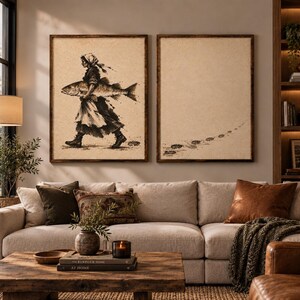 May include: Two rectangular framed wall art pieces featuring a sepia-toned illustration. The left print depicts a person in a headscarf and boots carrying a large fish. The right print shows a series of footprints leading across a textured background.