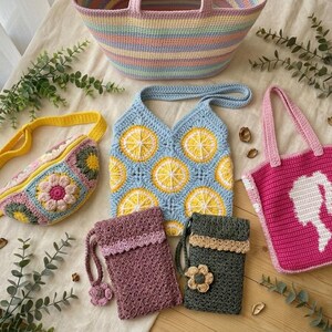May include: A collection of handmade crochet bags including a large pastel striped tote, a yellow fanny pack with floral motifs, a light blue lemon-patterned shoulder bag, a bright pink tote with a white silhouette, and two small pouches.