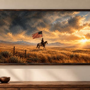 May include: A rectangular framed wall art print depicting a lone rider on horseback carrying an American flag across a golden prairie landscape at sunset. The scene features distant mountains, a wooden fence, and a dramatic sky with clouds.