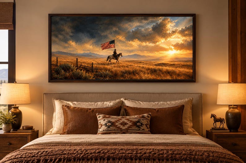 May include: A rectangular wall art print in a dark wood frame depicting a lone rider on horseback carrying an American flag across a golden prairie landscape at sunset, with dramatic clouds, distant mountains, and a wooden fence in the foreground.