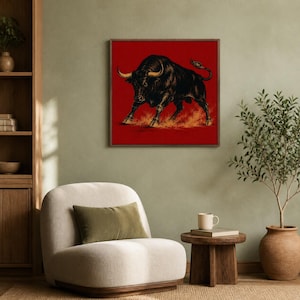 May include: A square wall art piece featuring a detailed illustration of a powerful black bull with curved horns, depicted in a charging stance against a solid red background with orange dust effects swirling around its hooves and legs.