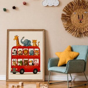 May include: A framed wall art print featuring a bright red double-decker bus filled with various illustrated animals, including a giraffe, elephant, lion, zebra, monkey, rhino, tiger, crocodile, bear, toucan, and flamingo on a cream background.
