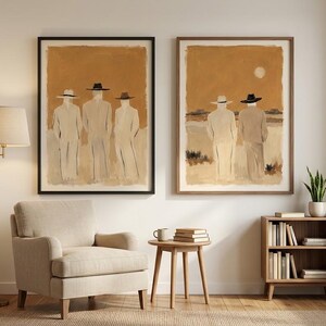 May include: Two framed wall art prints featuring abstract figures wearing hats against a warm ochre background. The left print shows three figures standing, while the right print depicts two figures in a landscape with a pale sun in the sky.