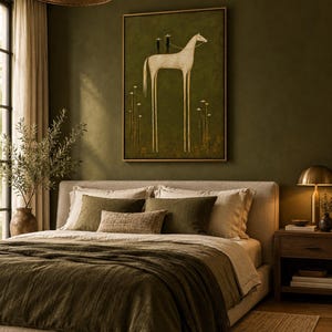 May include: A framed wall art print featuring a stylized white horse with elongated legs standing on a dark olive green background. Two small figures are positioned on the horse's back, surrounded by thin, delicate white floral stems.