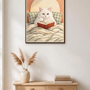 Framed print of a white cat reading in bed in an entryway — cute cat wall art, instant digital download