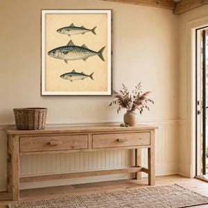Antique fish print in a wood frame above a rustic console table in a lake house entryway — vintage fish illustration, coastal nautical wall decor