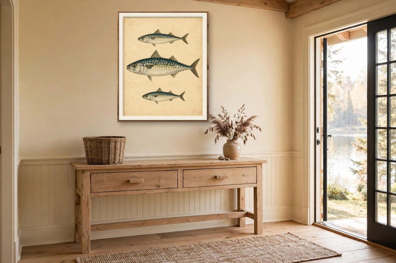 Antique fish print in a wood frame above a rustic console table in a lake house entryway — vintage fish illustration, coastal nautical wall decor