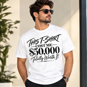 May include: A white short-sleeved t-shirt featuring bold black text that reads: This T-Shirt COST ME $50,000 Totally Worth It. The design is centred on the chest area, utilising a mix of script and block lettering styles for the graphic print.