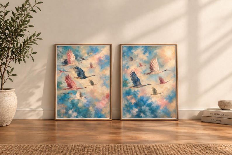 May include: Two framed rectangular wall art prints featuring oil-style paintings of flocks of birds in flight against a soft, blended sky of blue, pink, and white clouds. The birds are depicted in shades of pink, blue, and white with wings spread.