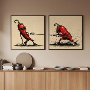 May include: Two square wall art prints featuring a red chilli pepper character wearing sunglasses and trainers. The left print shows the chilli pulling a rope, while the right print shows the chilli pulling with an intense expression and dust clouds.
