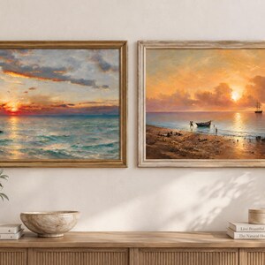 Puede incluir: Dos pinturas al óleo de paisajes enmarcadas que representan puestas de sol costeras. La pintura de la izquierda muestra un sol naranja vibrante sobre olas turquesas. La de la derecha presenta una playa con un bote, un barco y nubes doradas.