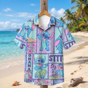 May include: A short-sleeve button-down shirt featuring a repeating grid pattern with blue Stitch characters, pink hibiscus flowers, and the text "OHANA" and "STITCH". The shirt has a notched collar, a white inner lining, and a light blue and purple color palette.