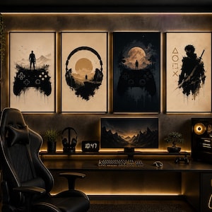 May include: Four framed wall art prints featuring black ink-style silhouettes of gaming controllers, headphones, and a warrior figure against beige and dark backgrounds. The artwork includes a person standing on a controller, a landscape, and symbols.
