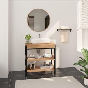 Puede incluir: Un mueble de baño con encimera de madera clara y dos estantes abiertos sostenidos por un marco de metal negro. Un lavabo rectangular blanco se asienta sobre la encimera, junto a un espejo redondo, un toallero negro y accesorios de baño.