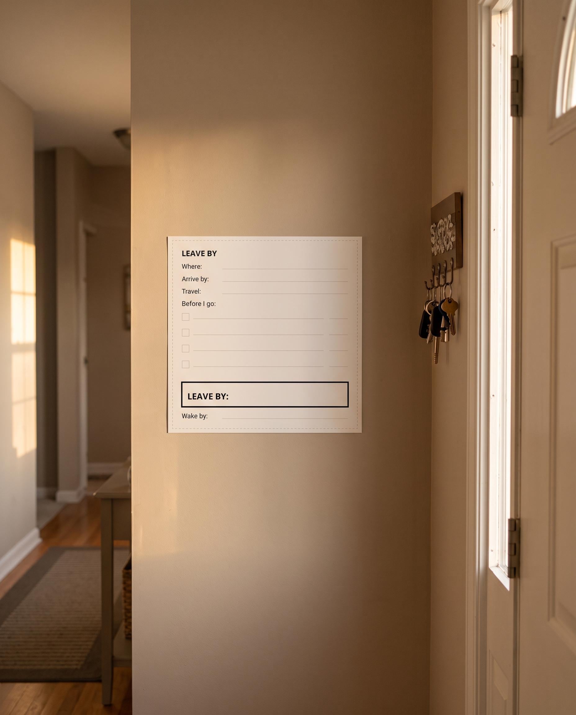 Leave By card taped beside a front door with arrive-by, travel time, before-I-go checklist and wake-by time